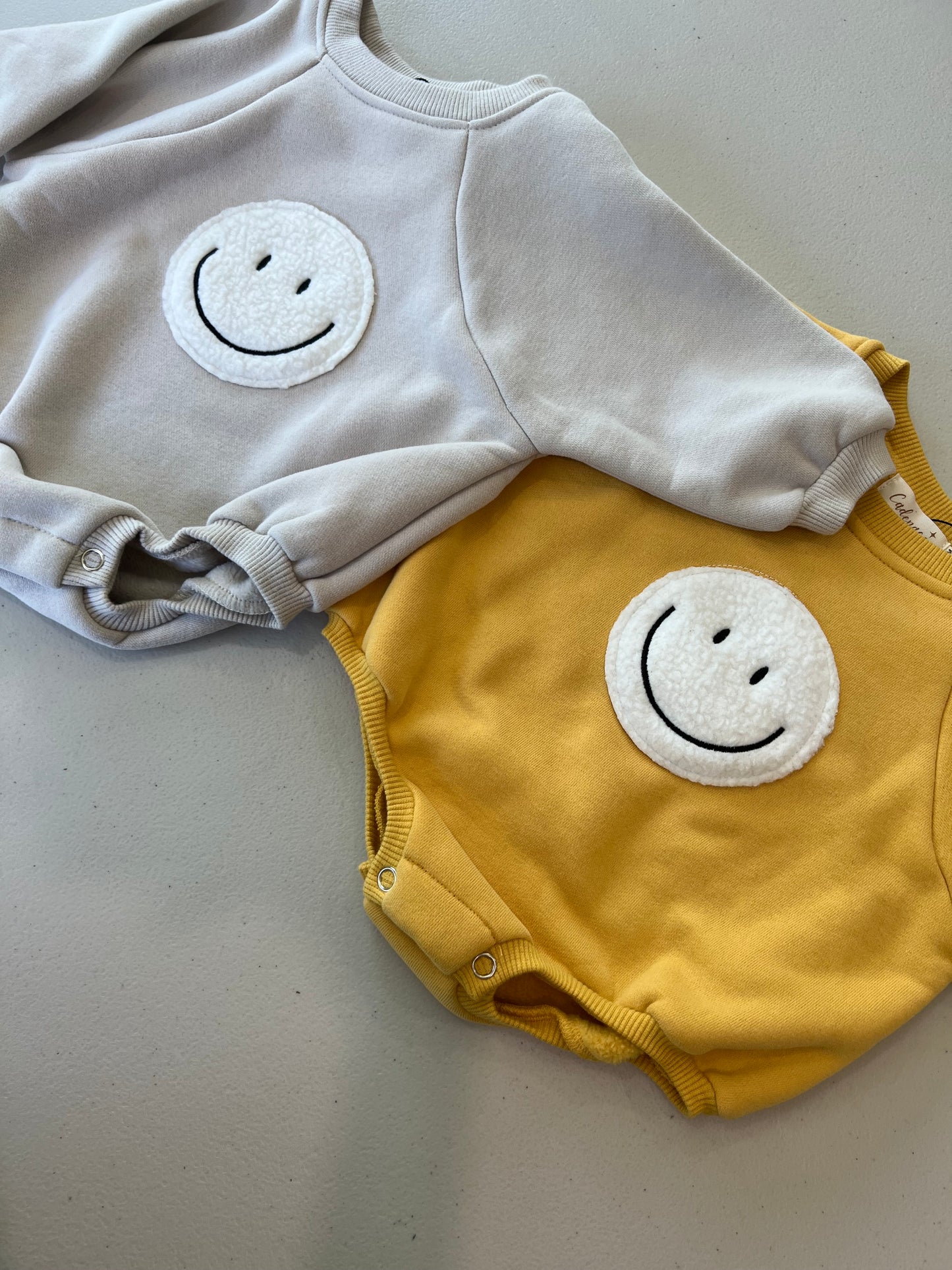 SMILEY FACE ROMPER